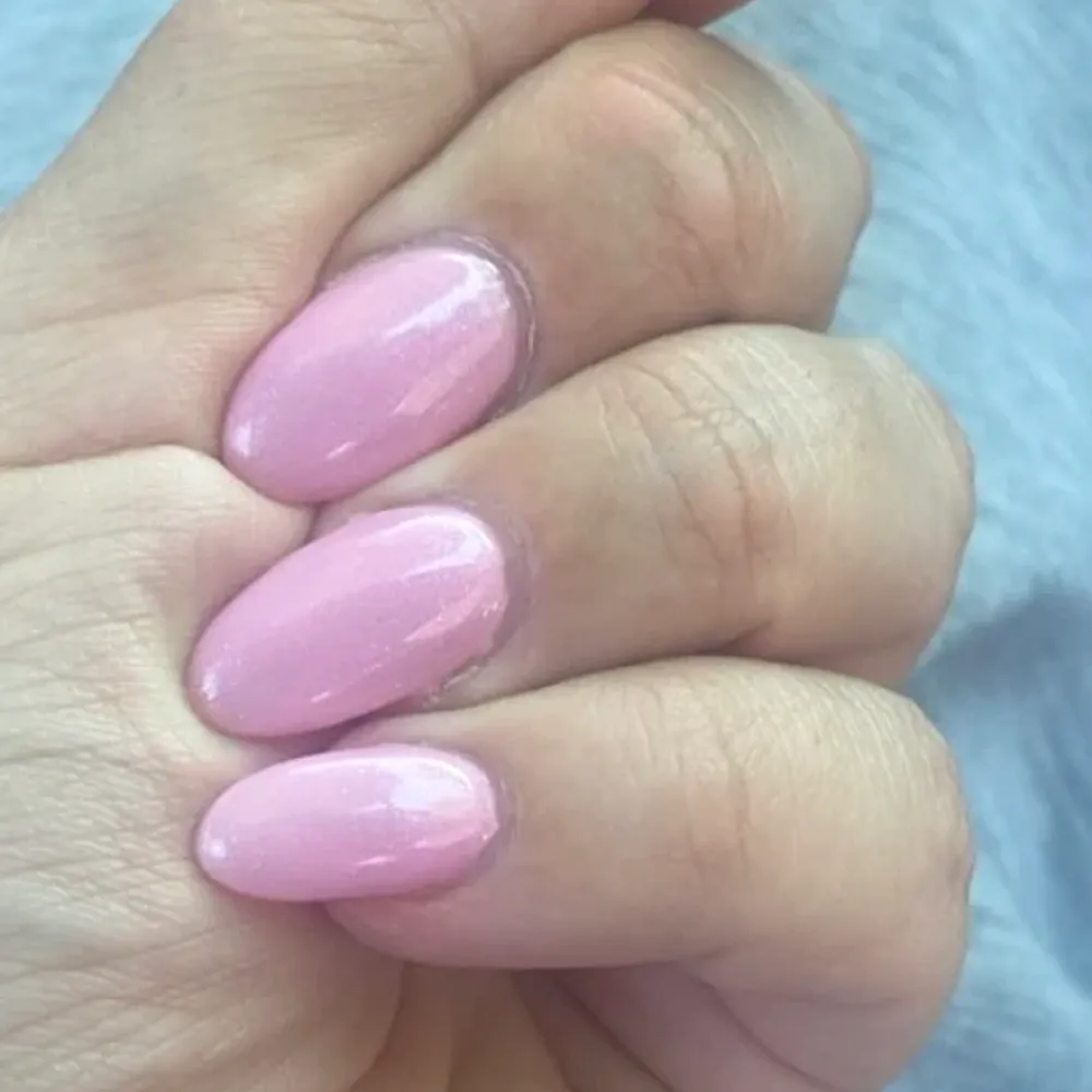 Glossy pink almond-shaped gel nails
