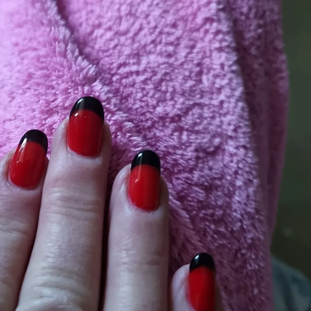 Red nails with bold black French tips